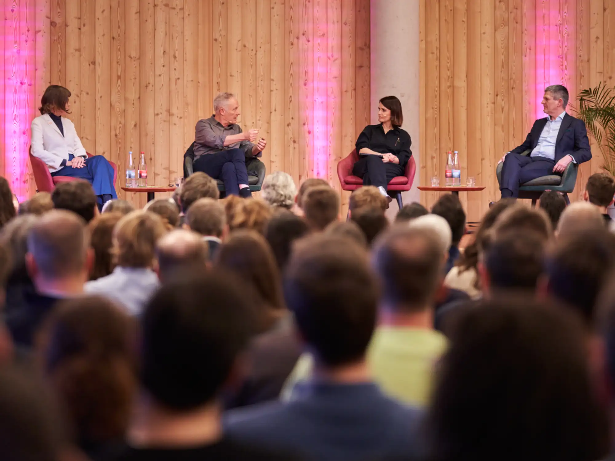 Panel discussion with business speakers and a professional audience